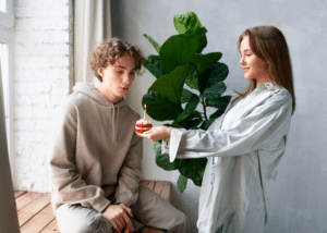 mom giving son a birthday cupcake