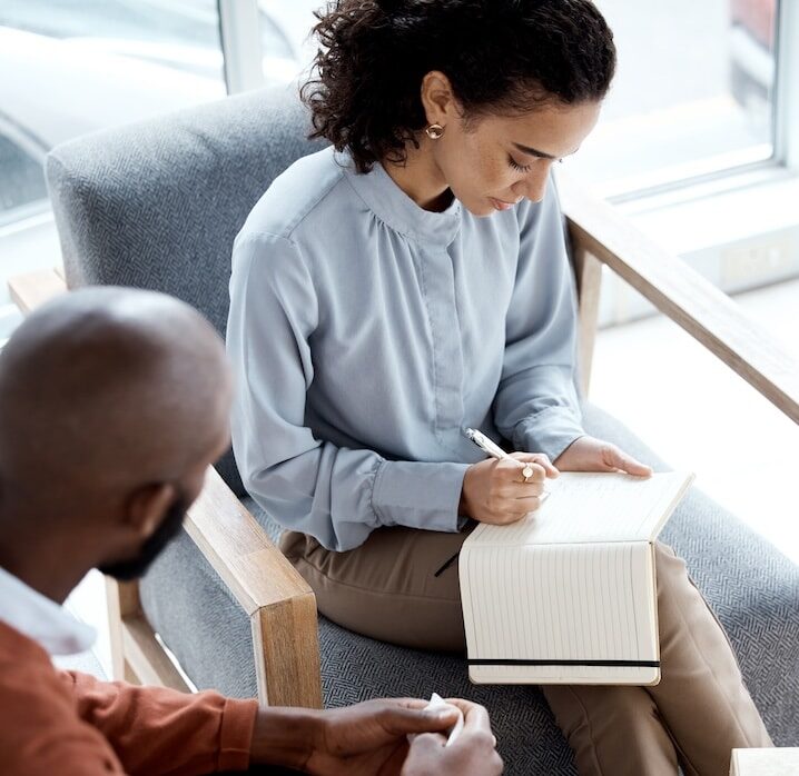 woman writing in journal to benefit her mental health