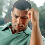 man looking down with hand on head considering the treatment approaches for dissociative identity disorder