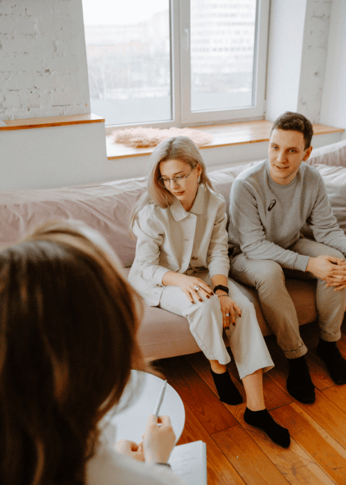Couple sitting on a sofa in a psychodynamic therapy session