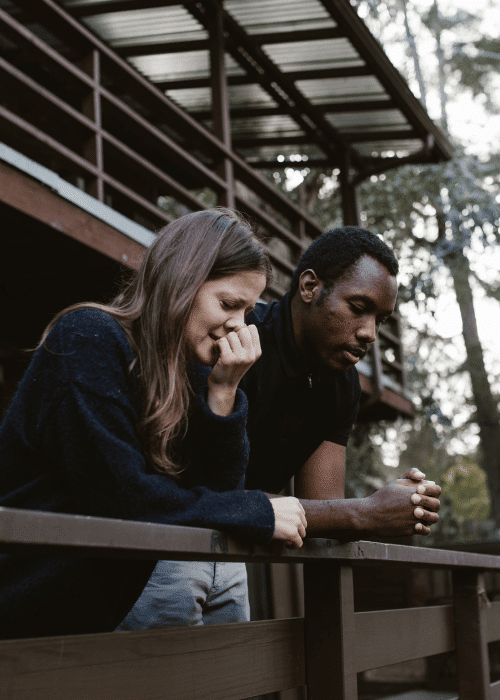 woman and man with types of adjustment disorders leaning on a balcony breaking up