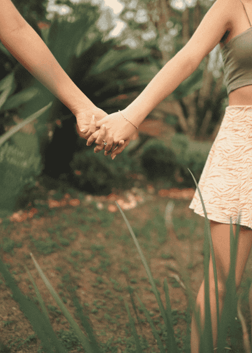 couple holding hands in the park with girl struggling with jealousy & insecurity in adults