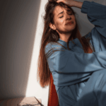 woman sitting against wall crying experiencing fear of abandonment in adults