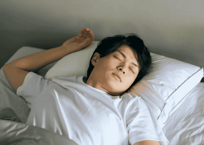 Man sleeping soundly in bed after support for sleep paralysis in adults