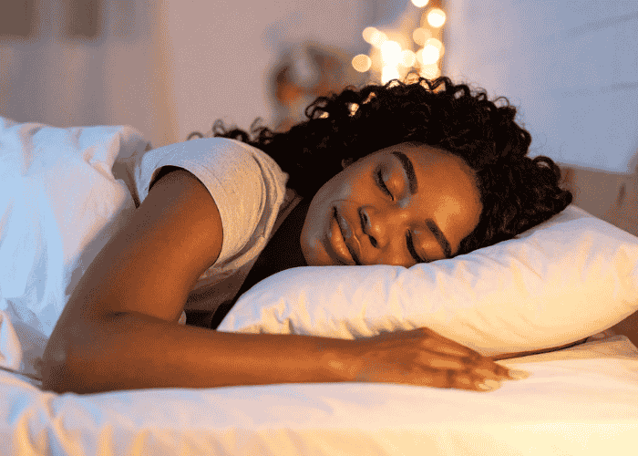 woman sleeping peacefully in bed after seeking treatment for nightmares in adults