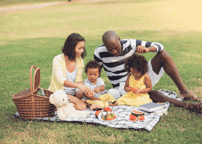 man eating picnic in park with family after treatment for emotional eating in adults