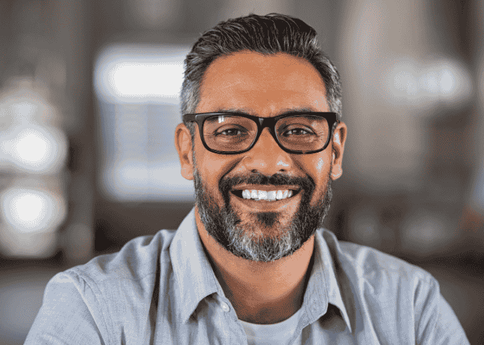 man in office smiling because he is no longer experiencing dissociation in adults
