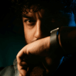 man with hand on face looking angry due to self-destructive behavior in adults