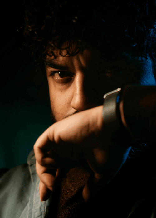 man with hand on face looking angry due to self-destructive behavior in adults