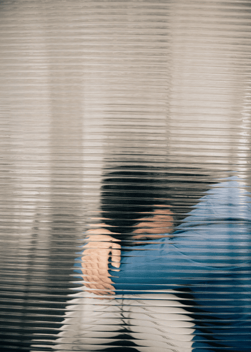 Woman sitting with her knees drawn up to her stomach struggling with emotional numbness in adults