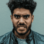 Angry man looking at the camera with an angry facial expression due to emotional overreactions in adults