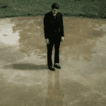 Man standing on his own in the rain unsure what to do due to indecisiveness in adults