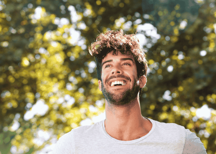 Man walking outside looking relieved due to getting treatment for restlessness in adults