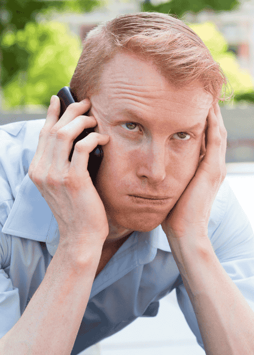 man experiencing irritability in adults on phone