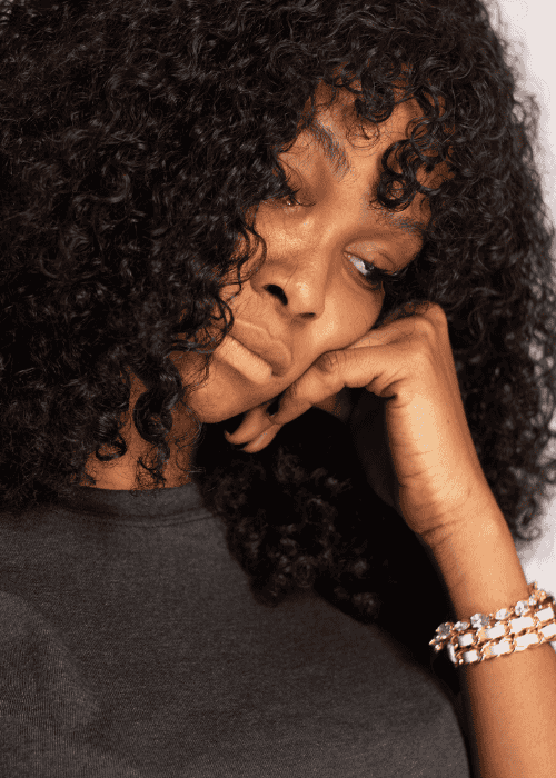 woman experiencing mood swings in adults looking unhappy with head on hand