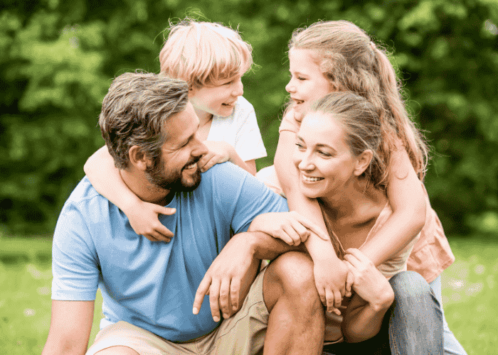 woman smiling with family after treatment for irritability