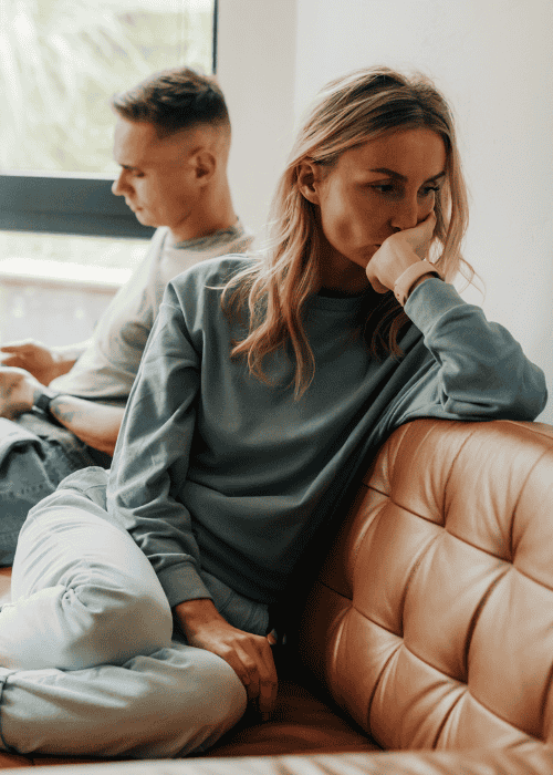 Woman say on sofa with back to partner due to fear of intimacy in adults