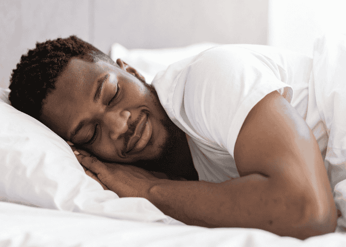 man in bed sleeping peacefully after treatment for parasomnias in adults