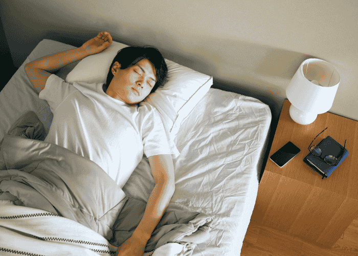 man in bed sleeping peacefully after treatment for nighttime anxiety