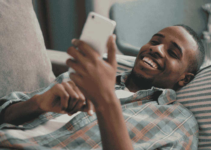 Man standing outside smiling after receiving treatment for bruxism in adults