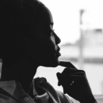 Woman looking thoughtfully out of the window, struggling with compulsive mental checking in adults