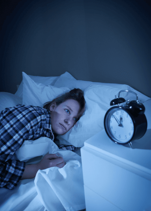 Woman awake in the middle of the night due to sleep disruption in adults