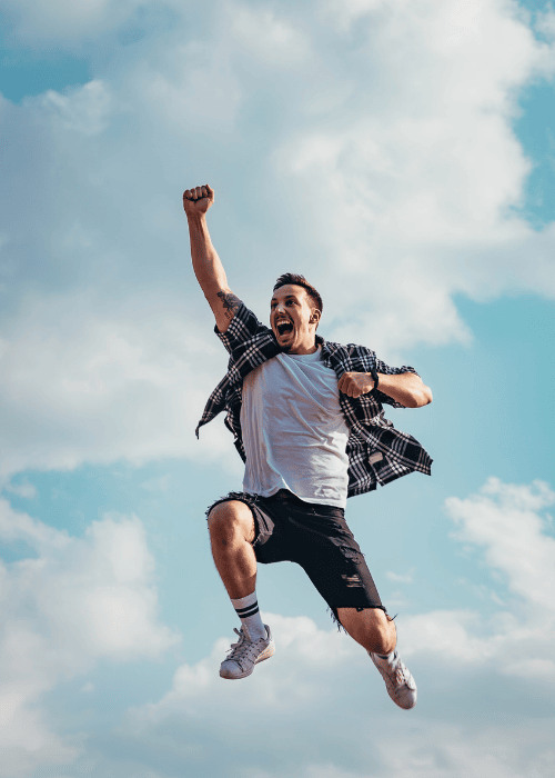 Man jumping into the air showing hypomania symptoms in adults