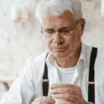 Man in suspenders exhibiting nervous fidgeting in adults