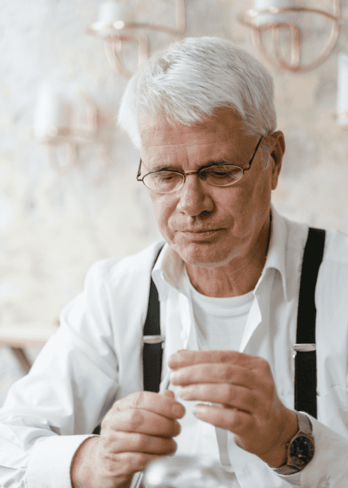 Man in suspenders exhibiting nervous fidgeting in adults