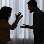Silhouette of couple arguing with hands held up in frustration, needing support with how cognitive distortions affect relationships