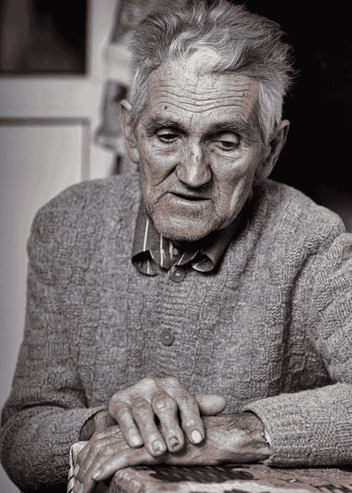 man sitting at table worrying about Sharp Health Plan mental health insurance coverage