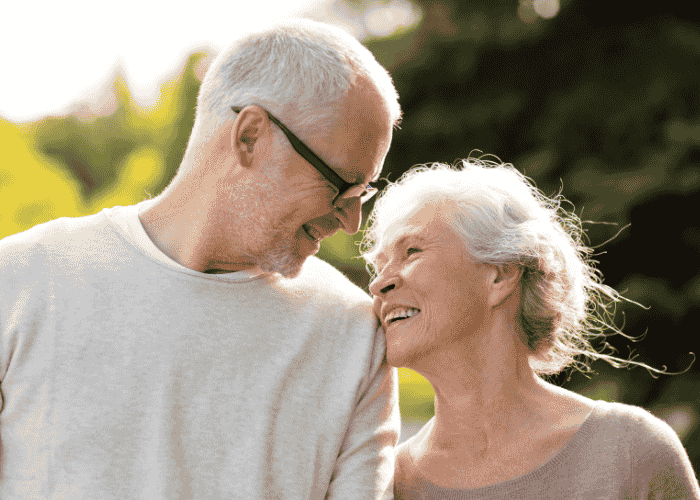 man outside in garden with wife looking at her and smiling afrer receiving support with First Health Network mental health insurance coverage
