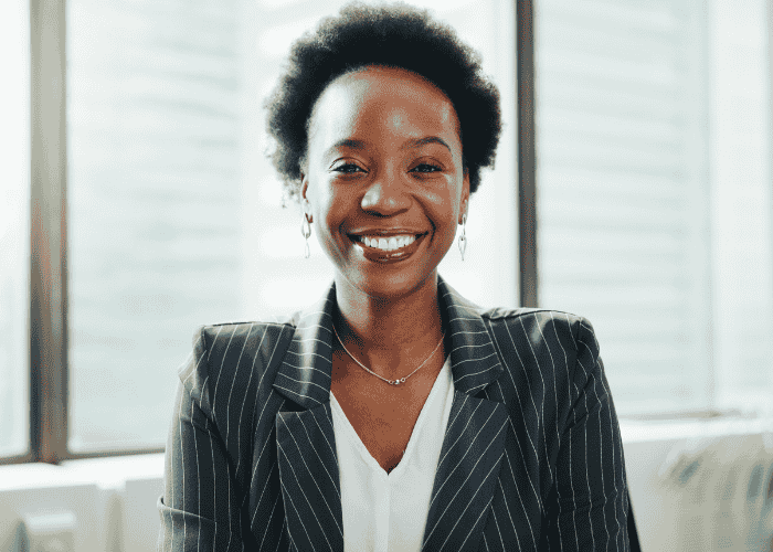 Woman in office smiling after receiving support via Halcyon Behavioral Health Insurance