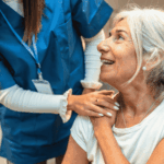 Older woman smiling up at nurse after receiving Virginia mental health crisis response services