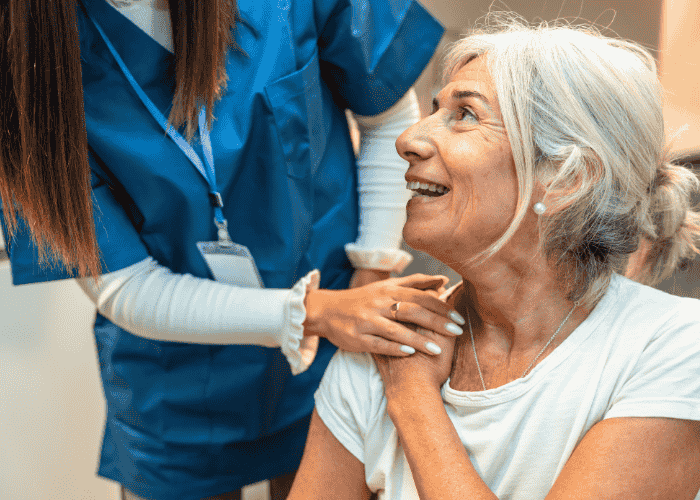 Older woman smiling up at nurse after receiving Virginia mental health crisis response services