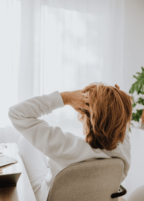 Woman with her head in her hands due to the mental health access gap