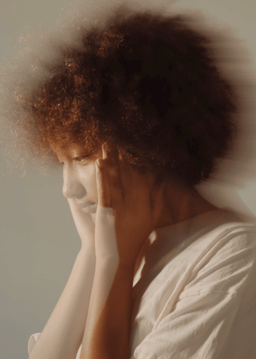 Woman looking distressed due to imposter syndrome as a cognitive distortion