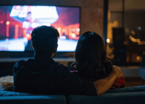 Man and woman watching TV wondering how the media shapes our understanding of mental health