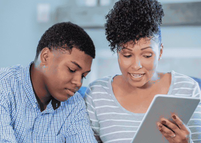 Man and woman using tablet for telehealth call after researching the future of mental health