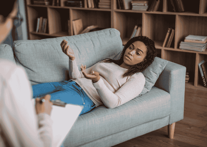 A woman in therapy session after researching regulations around how AI Is used for improving mental health