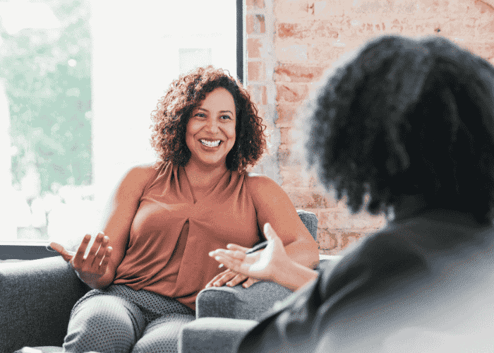 Woman smiling in therapy session after seeking support with what to do needing info on what to do when mental health coverage is denied in California