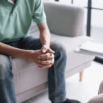 Man in therapy session sitting on sofa wondering how to make the most out of mental health appointments