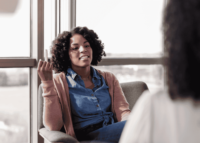 Woman smiling in therapy session after support with how to make the most out of mental health appointments
