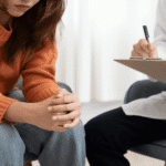 Woman sitting in therapy session after seeking early intervention in mental health
