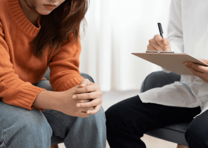 Woman sitting in therapy session after seeking early intervention in mental health