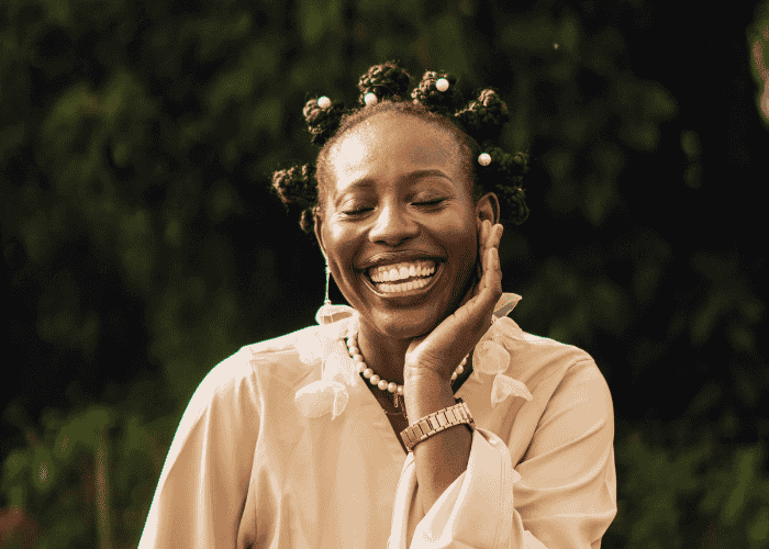 Woman smiling and looking happy after finding out how cognitive distortions shape thinking and behavior