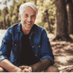 Man sitting outdoors smiling and happy after receiving treatment for cognitive distortions in ocd