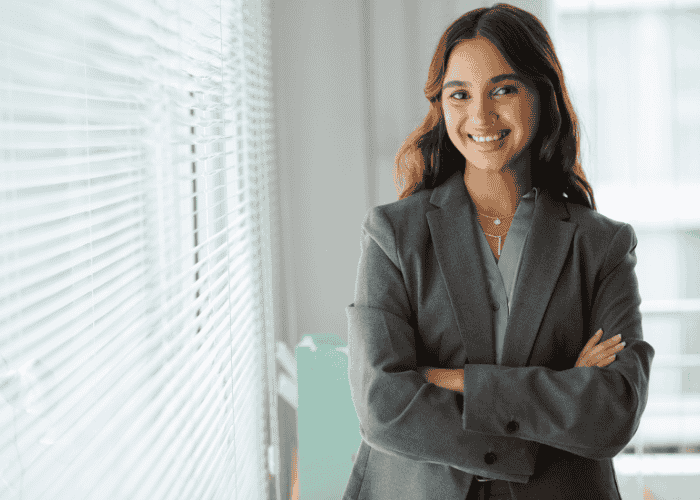 Woman happy at work due to receiving therapy for imposter syndrome as a cognitive distortion