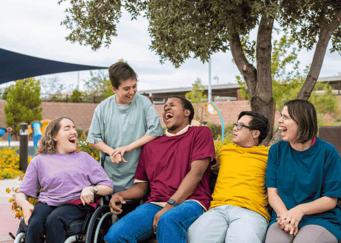 Group of individuals with disabilities celebrating due to support for the link between disability and mental health