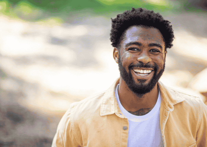 Man of color happy after learning how telehealth helps rural/underserved communities